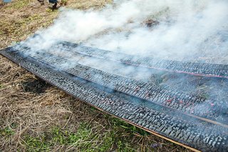 After the flames have been put out, the boards continue to crackle and smoke. Charring the boards properly requires a delicate balance between just enough burning, but not too much.