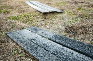 The primitive and painstaking process is said to protect wood against rain, rot, and insects for 80 years. It also gives the exteriors a reptilian texture that’s as striking as it is practical.
