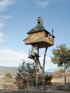 Fujimori's retreat in Nagano, The Too-High Tea House, which is adorned with a roof of hand-rolled copper sheets, seems precariously perched atop a pair of tree trunks 20 feet in the sky. Why two? "One leg is dangerous and three legs are too stable and boring."