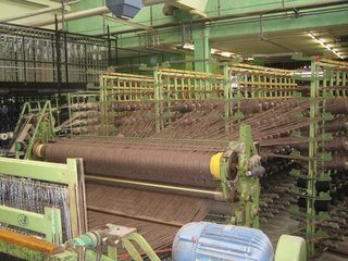 Touring Switzerland: Day 3 - Photo 1 of 4 - One of the massive weaving machines at Ruckstuhl, where up to 3600 spools of thread are needed for each rug.