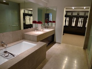 The W Hollywood Residences - Photo 8 of 10 - The bathrooms feature fossilized Brazilian limestone, Kohler fixtures, and Poliform closets.