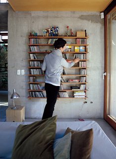 Hernaez organizes CDs on a modular lapacho wood shelf designed by Sticotti.