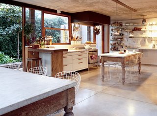 In the kitchen, buffed concrete floors, chrome globe lights, and a fleet of Bertoia chairs comprise a sleek backdrop for quirkier pieces like the marble-topped wooden tables from a Catholic school, snagged at a local flea market. The secret to the spare, uncluttered shelves? A dispensa, or walk-in pantry, down the hall. "We hide everything we don’t want to see," Sticotti explains. "We don’t want to have to look at brands."