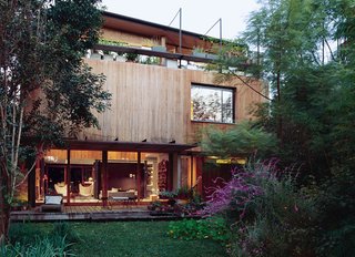 Even the economy has regions, Alejandro Sticotti and Mercedes Hernaez discovered when Argentina's economy collapsed. This led them to build a house from local woods and materials, creating a house that is "of Argentina"—and proud of it. Here, a ground-level patio and third-floor deck overlook a lush front garden; sitting out there is like "being on vacation," says Hernaez.