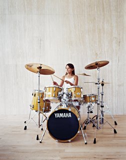 Berlin Jespersen, 8, daintily rocks the family drum kit, which Brent is also learning to play.