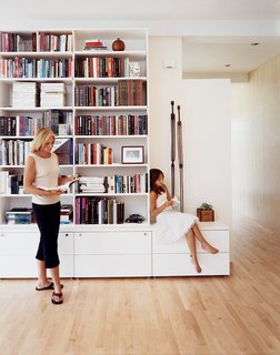 The main living room, separated by a freestanding wall, continues into an open study. The bookshelves, close to ten feet tall, are home to numerous architectural books, philosophy texts, and the literary work of Ayn Rand. Recessed speakers emanate music throughout, dependant on the wills of Jespersens' iPod.