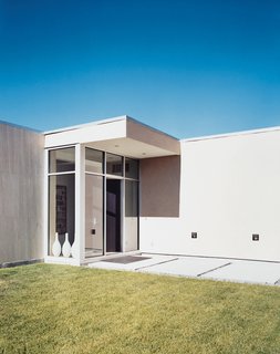 A meticulously manicured lawn complements the pared-down lines and massive front door. By night the path is illuminated by floodlights, which almost succeed in deterring the local wildlife. Almost—Jespersen notes that deer, moose, and other hoofed beasts visit the property on a regular basis.