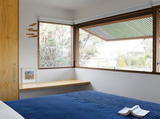 Nick’s father, Glenn Murcutt, insists on banks of sliding windows, louvers, and fly screens to allow for both natural ventilation and wintertime heat retention. Here Neeson and Murcutt opted for something simpler: large custom-made windows by Windoor that push out from below. Operated by a simple hydraulic system, these windows have spotted-gum slats, which allow for privacy. To keep out mosquitoes, the architects used a thin metallic screen from Phoenix Fly Screens to sit flush against the window. Held in place by magnets, it’s easily pulled away for storage in the wintertime.