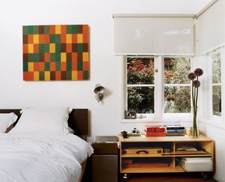 Day designed the plywood-and-aluminum platform bed in the master bedroom, which also opens onto a shady private terrace. The painting is by An Te Liu.