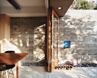 How This Couple Broke The Rules in a LA Suburb - Photo 2 of 9 - The elevated dining room opens out to a side patio, which climbs the wall just behind the house.