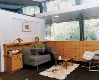 Buckner takes time out for the newspaper and a cup of tea in a lounge off of the couple’s bedroom. The bedroom, which sits within the cantilevered section of the house, was at one time a covered deck. The storage units are from a later renovation, but Buckner, who has expert knowledge of all of the original MHA homes, surmises that "something very similar" would have been in its place.