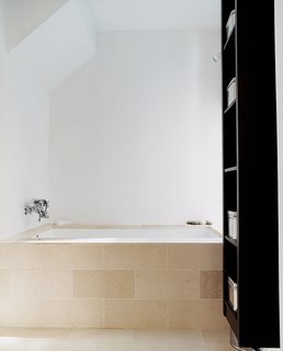 Kaleidoscopic Cabinet - Photo 6 of 8 - In the master bath, a Zuma tub with Hansgrohe fixtures is covered with limestone tile to soak up the sunshine.