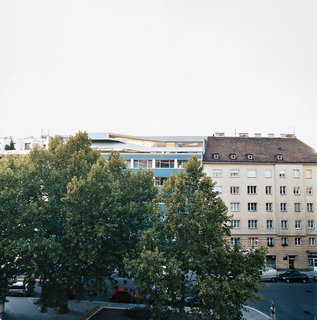The penthouse is boldly inserted within the traditional rooftops in Vienna's Wieden district.