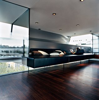 Meissl and Delugan’s favorite part of the house is definitely the "relaxation zone," which features a black leather platform of their own design that appears to float between layers of tempered glass. The pillows are by Herman Miller.