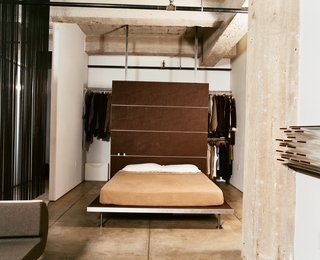 Cutting Up a Mini Loft in Los Angeles - Photo 6 of 9 - With a push of the sliding door, the bedroom morphs into an extension of the living room, adding much-appreciated square feet during dinner parties and other gatherings. The platform bed and backrest are both Tag Front designs.