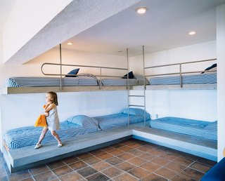 The rounded steel guardrails on the kids’ bunk beds are meant to inspire fantasies of nautical adventures.