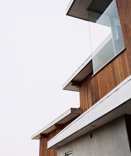 Two Houses Are Better Than One - Photo 2 of 13 - Galvanized-aluminum flashing is used to hide lighting fixtures and to delineate the tops of the redwood-strip walls. "It’s a simple palette of materials," says architect Jesse Bornstein.