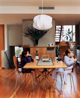Two Houses Are Better Than One - Photo 9 of 13 - Kalia and Olivia in the dining room (the Danish dining table was acquired by Jesse’s parents in the mid-’70s, the dining chairs are by Arne Jacobsen, and the light fixture is by George Nelson).