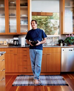 Two Houses Are Better Than One - Photo 11 of 13 - The architect at home in his kitchen with cabinetry that he also designed.