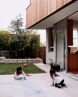 Two Houses Are Better Than One - Photo 13 of 13 - Kalia and Olivia enjoying the outdoor space. Kalia’s favorite part of the house? In her own words, "I like the backyard where we play soccer, hopscotch, and jump rope and draw and have picnics." ’Nuff said.