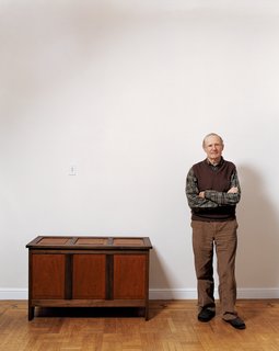 Simon Watts stands next to a mahogany-and-walnut chest—just one of many pieces he has rebuilt to replace all of the furniture that was mysteriously taken from his home last year.