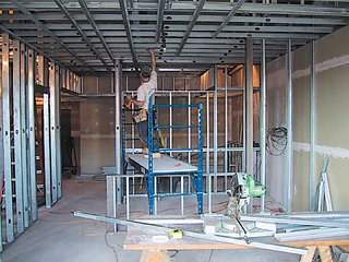 Urban Usonian - Photo 2 of 5 - Working within an empty shell, the design had to accommodate plumbing fixtures and existing concrete floors and ceilings.
