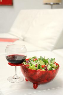 MooM bowl, by Giovanni Alessi Anghini for A Di Alessi.<br><br>Dinner's all made but American Idol is on. What do you do? Put your pasta or salad into the MooM bowl, pour yourself a glass of wine and slip it into the special hook to hold your Merlot, and lean back on the couch with your piping hot meal.
