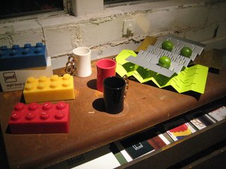 Ford + Ching Comes to Oakland - Photo 3 of 8 - Cool, colorful accessories from PAD Outdoor: 8 Knob Candles, Gold Knuckles mugs, and serving trays/fruit bowls.