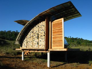 A sideview of the cabana shows off the most artistic facet of the design, where recycled bottles are embedded in the wall.