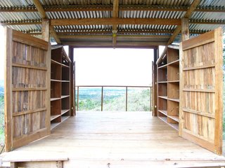 The interior of the cabana is relatively tight but with the sides open, the space feels breezy. Built-in shelving makes storage easier, leaving room for beds, chairs and tables.