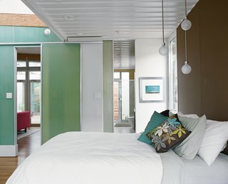 The Shipping Muse - Photo 9 of 23 - The master bedroom is another place where Robertson placed emphasis on the existing size and shape of the containers. The room opens up to a clerestory window beyond the foot of the bed but the exposed edge of the container ceiling makes "you almost feel like a hobo on a train," Feldmann says, romanticizing about her view from bed.