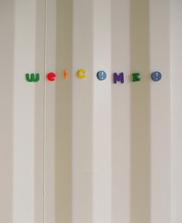 The Shipping Muse - Photo 15 of 23 - The corrugated steel of the container that houses the master suite becomes a textured wall for writing messages in the home's entrance. "When we were furnishing the house, I thought, 'Oh no! Our fridge isn't magnetic for Eli's artwork,' but then I realized the whole house is magnetic," Feldmann says. "We've become magnet connoisseurs," Freeman adds.