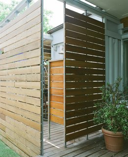The Shipping Muse - Photo 16 of 23 - The outdoor shower can be accessed through the master bathroom or from the back porch, which is nice after a long bike ride on a hot Houston day--especially since the couple stores several of their nine bikes inside the walled-off shower space.