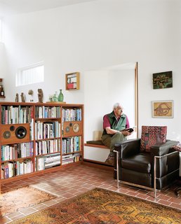 One of the coziest nooks in the house is in the living room, a window seat where Cohen sits and reads. Because the large glass window in the living room is fixed, the smaller one opens to allow cross breezes and ventilation.