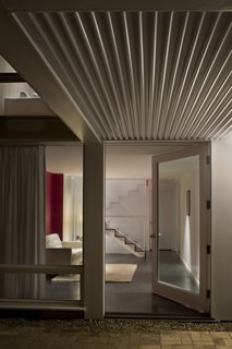 Noe Valley Renovation - Photo 14 of 17 - Before the renovation, the bottom floor consisted of dark, unfinished rooms. To brighten the space and create an extension of the public areas above, Samaha and Hart extended the stairwell to the bottom floor and created a cantilevered deck to eliminate barriers that would obstruct light from infiltrating the space.<br><br>Photo by <br><br>Sharon Risedorph