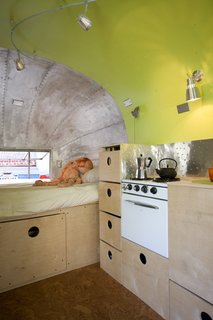 I was intent on keeping the original stove, incorporating it into the cabinetry. I created a backsplash using inexpensive aluminum flashing that I texturized with a ball-peen hammer.