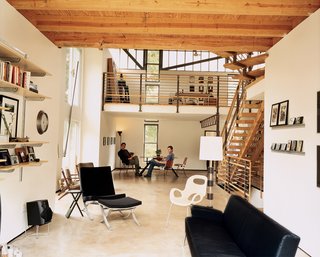 The house is designed like an urban loft. Even elements such as the staircase and second-floor railings are almost transparent, so natural light floods the structure from dawn to dusk. Moseley's friend David W. Prasse (right) and designer Scott Ball take it all in.