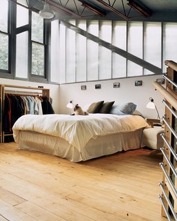 No alarm clock needed here. The highest point in the house is the bedroom, bathed in light from two walls made predominantly of windows and a third completely open to the rest of the house.