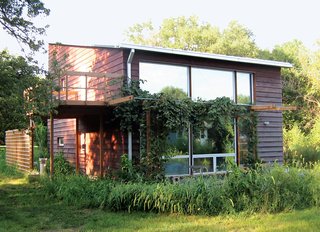 Passive Acceptance - Photo 2 of 2 - In Katrin Klingenberg’s house, a completely airtight design doesn’t leave her lacking a sense of openness. A two-story wall of windows invites sunlight in during the day, maximized through the thoughtful orientation of the building on its site. Photograph courtesy Passive House Institute U.S.