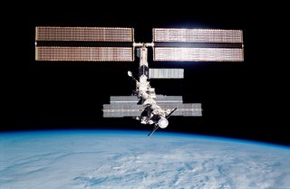 Backdropped against the blackness of space and the Earth's horizon, the ISS was photographed through an aft flight deck window following separation from the Space Shuttle Endeavour. Photo taken December 15, 2001. Image courtesy of NASA.
