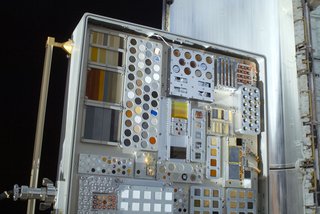 A close-up view of a Materials International Space Station Experiment (MISSE-6) on the exterior of the Columbus laboratory is featured in this image photographed by a space walking astronaut during the STS-128 mission's first session of extravehicular activity (EVA). MISSE collects information on how different materials weather in the environment of space. MISSE was later placed in Space Shuttle Discovery's payload bay for its return to Earth. A portion of a payload bay door is visible in the background. Photo taken September 1, 2009. Image courtesy of NASA.
