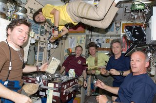 Crew members on the ISS share a meal near the galley in the Zvezda Service Module. Pictured from the left are NASA astronaut Michael Barratt, Expedition 19/20 flight engineer; European Space Agency astronaut Frank De Winne, Expedition 20 flight engineer and Expedition 21 commander; Russian cosmonaut Gennady Padalka, Expedition 19/20 commander; Canadian Space Agency astronaut Robert Thirsk, Expedition 20/21 flight engineer; and NASA astronaut Jeffrey Williams, Expedition 21 flight engineer and Expedition 22 commander; along with NASA astronaut Nicole Stott, Expedition 20/21 flight engineer. Photo taken October 5, 2009. Image courtesy of NASA.