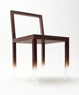 The "Fade-Out" chair, a simple rectangular chair made from clear acrylic and painted with trompe l’oeil wood grain over most of the structure. The pattern fades away on the lower part of the chair legs to create the impression that the chairs are floating in space. Image courtesy Masayuki Hayashi.