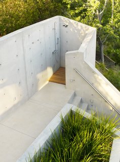 An Atypical Tree House - Photo 10 of 11 - The outdoor shower below the tree house was shaped and formed from concrete to be a truly private experience.