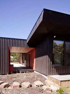 30 All-Black Exterior Modern Homes - Photo 13 of 30 - Courtyard House, Location: Somers Victoria Australia, Architect: Rowan Opat .Evolving from the notion of a series of outbuildings on a greenfi eld site, principles of passive solar design have informed this courtyard house. The northern eaves respond directly to shading becoming shallower in proportion to the depth of space as experienced in the square plan. As the dominant designed area, on this hectare site, the courtyard both surrounds and is surrounded by the house, creating a contained space within an otherwise semi-rural block.