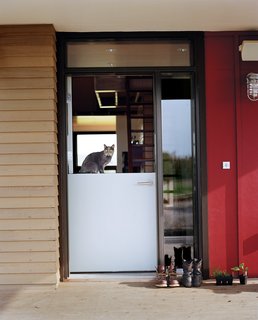 Cultivating the land keeps the Moumings in a frequent rotation in and out of the house. <br><br>A Dutch door lets indoor and outdoor tasks flow together easily as they go about their day (with Yuri the cat standing guard).