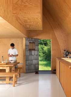 The exposed-wood motif continues inside, where plywood walls, as well as Barache and his guests, keep things warm.