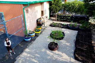 A student poses next to the edible schoolyard created at Santa Monica Boulevard Charter School.<br><br>Photo by <br><br>Suthi Picotte