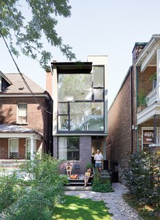 Karen White, David MacNaughtan, and their sons, Griffin and Finlay, hang out on the front deck, which lines up next to the neighbors' porch.