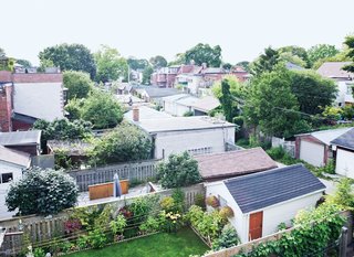At the top, the view from the roof deck reveals a patchwork of garages and yards surprisingly free of neighbors.